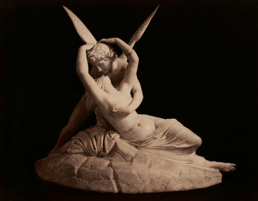 Cupid and psyche statue embracing romantically.