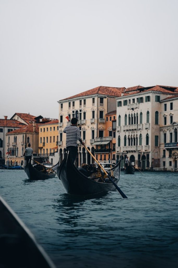 A couple of gondolas that are sitting in the water
